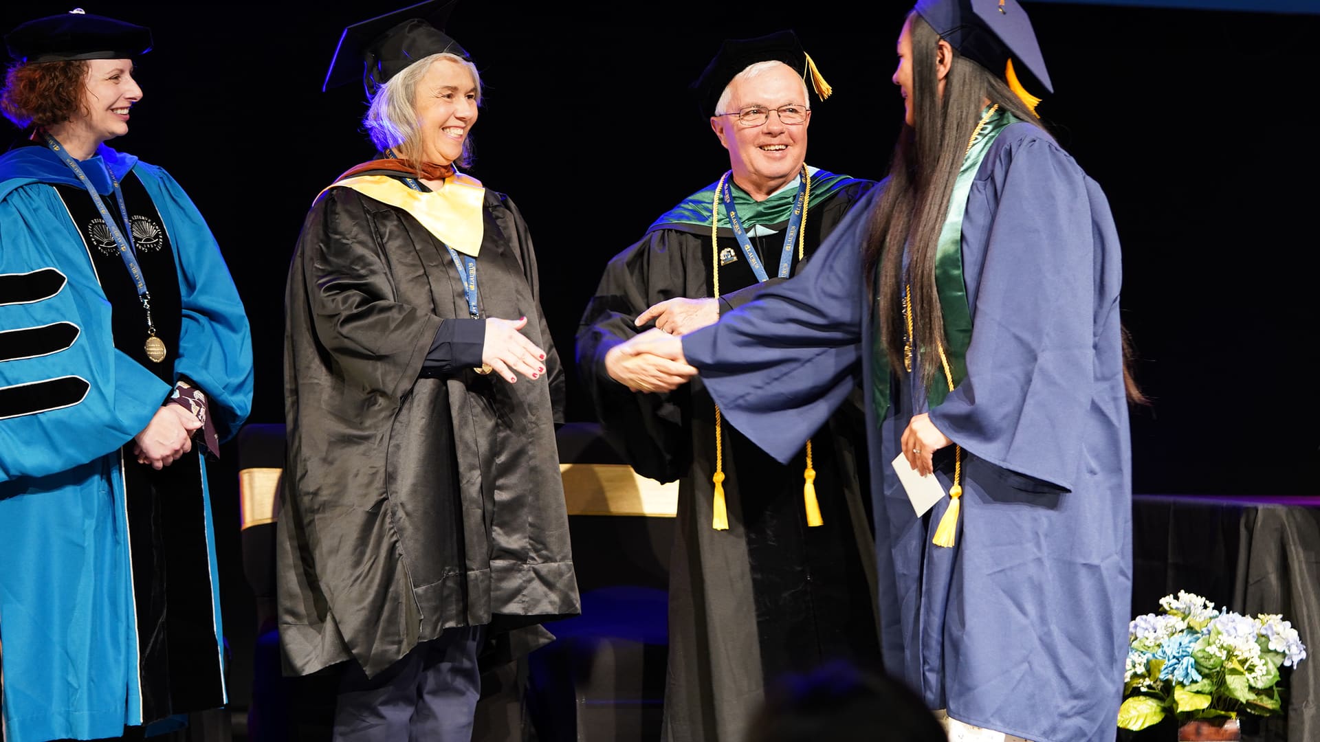 A Laurus College graduate crossing the commencement stage