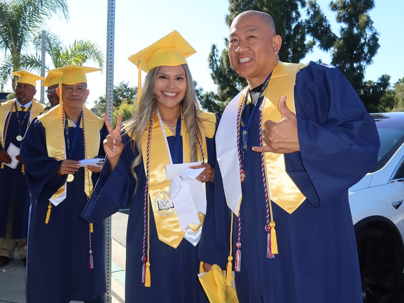 Laurus College graduates smiling in caps and gowns outside a commencement venue