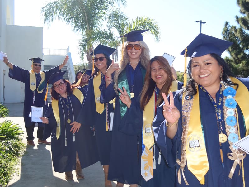 A line of Laurus College graduates walking to a commencement ceremony