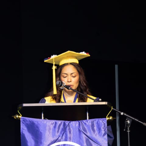 Veronica B. Hernández speaking at her Laurus College commencement ceremony