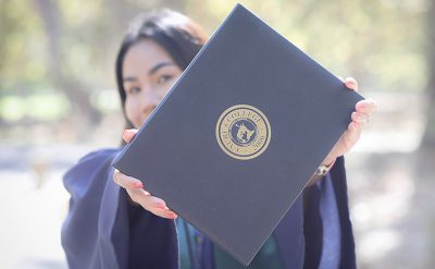 Riza Monaya Holding a Diploma