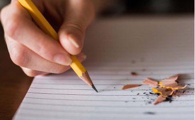 A student using a pencil on a piece of paper