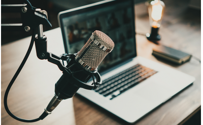 Podcast setup with microphone and laptop