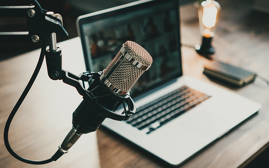 A podcast setup with microphone and laptop