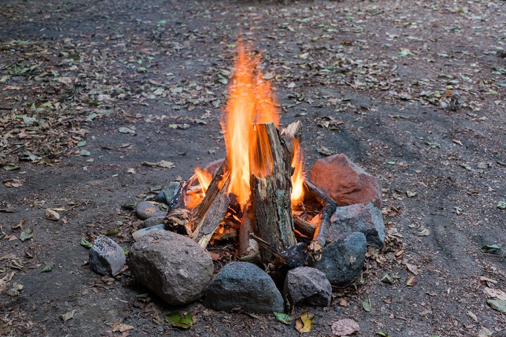 A campfire surrounded by stones